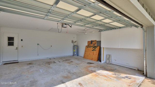 garage with ceiling fan, a garage door opener, and water heater