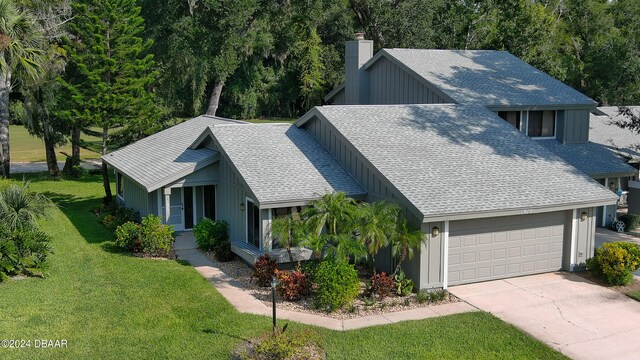 view of front of home featuring a garage and a front lawn