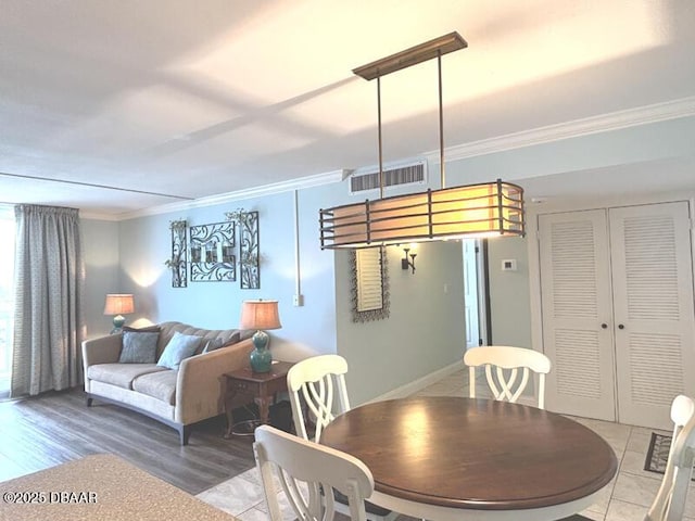 2800 N Atlantic Ave Unit 1206, Daytona Beach, FL 32118 - dining space with ornamental molding and light wood-style floors