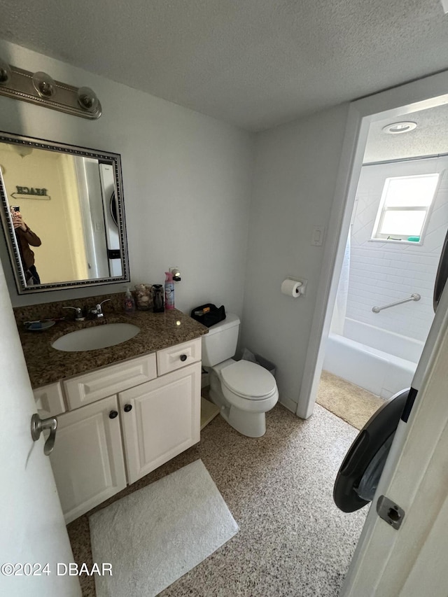 full bathroom with shower / tub combo with curtain, vanity, a textured ceiling, and toilet