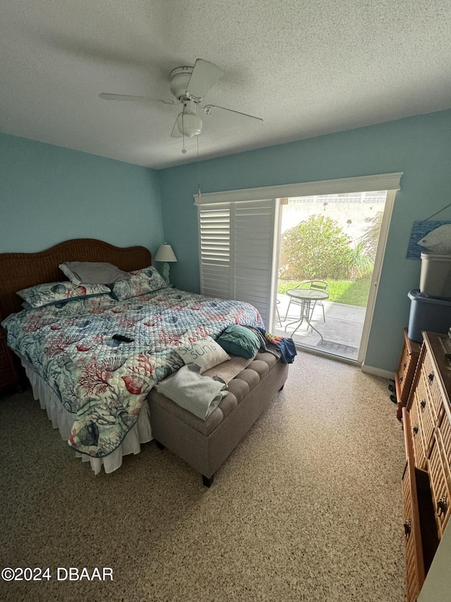 bedroom with a textured ceiling, ceiling fan, and access to exterior