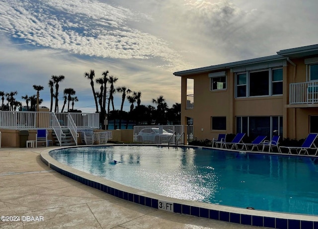 view of swimming pool featuring a patio area