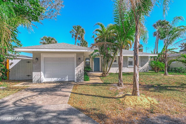 single story home with a garage and a front lawn