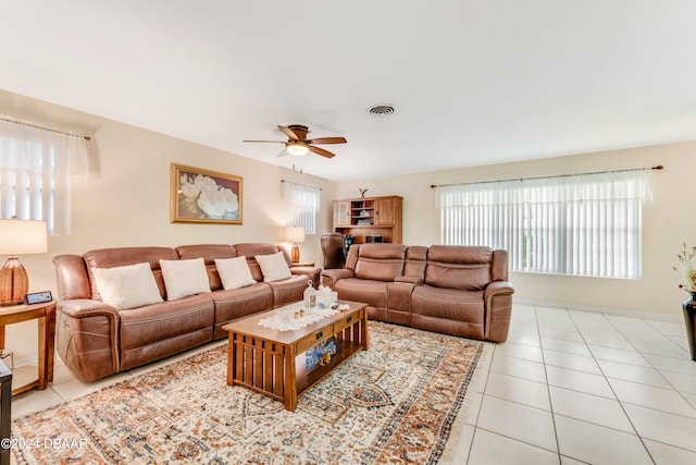 living room featuring ceiling fan and light tile patterned flooring