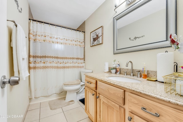 bathroom featuring vanity, tile patterned flooring, and toilet