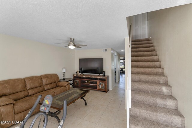 5500 Ocean Shore Blvd Unit 58, Ormond Beach, FL 32176 - living area featuring ceiling fan, light tile patterned floors, stairs, and a textured ceiling