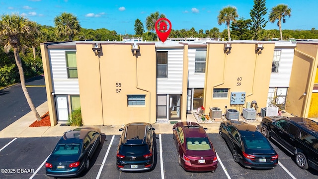5500 Ocean Shore Blvd Unit 58, Ormond Beach, FL 32176 - view of property featuring uncovered parking and central AC