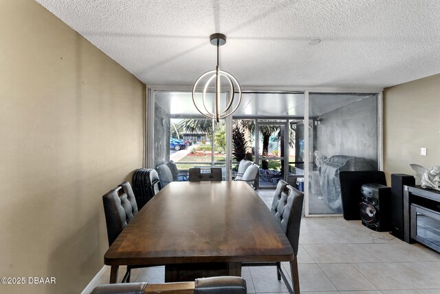 5500 Ocean Shore Blvd Unit 58, Ormond Beach, FL 32176 - dining room featuring a chandelier, a textured ceiling, and light tile patterned flooring