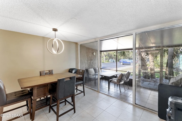 5500 Ocean Shore Blvd Unit 58, Ormond Beach, FL 32176 - dining room featuring a textured ceiling, expansive windows, and light tile patterned floors