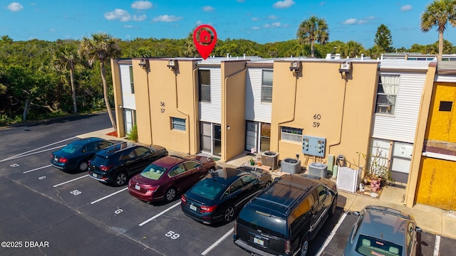 5500 Ocean Shore Blvd Unit 58, Ormond Beach, FL 32176 - view of property featuring uncovered parking and central AC unit