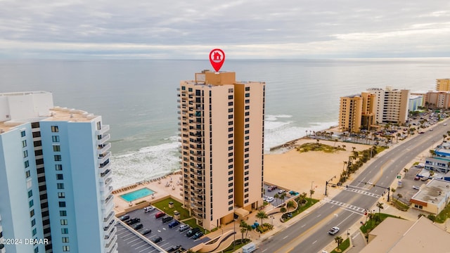 drone / aerial view with a water view and a beach view