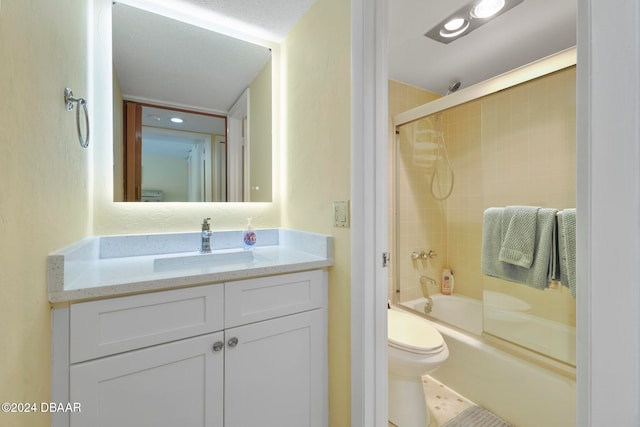 full bathroom featuring vanity, toilet, and bath / shower combo with glass door