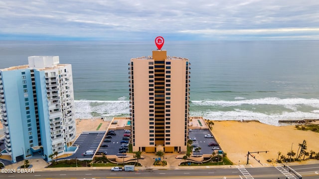 drone / aerial view with a water view and a beach view