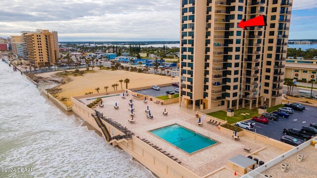 exterior space featuring a water view and a view of the beach