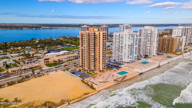 birds eye view of property featuring a beach view and a water view