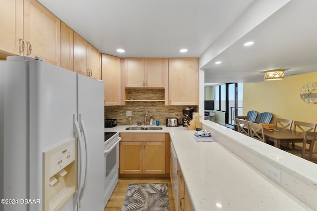 kitchen featuring light brown cabinets, white appliances, sink, and light hardwood / wood-style flooring