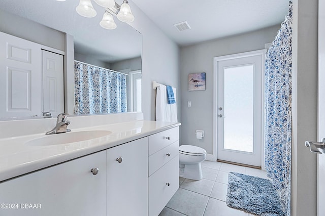 1317 Harwick Ln, Ormond Beach, FL 32174 - full bath with toilet, vanity, tile patterned floors, a chandelier, and curtained shower