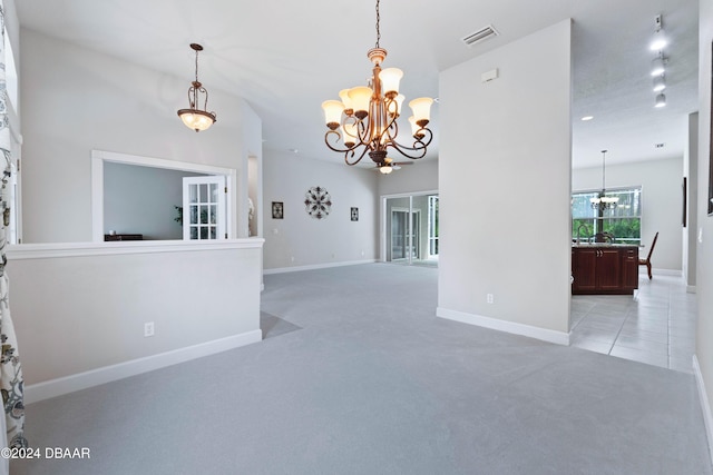 1317 Harwick Ln, Ormond Beach, FL 32174 - unfurnished room featuring a chandelier, light colored carpet, baseboards, and light tile patterned flooring