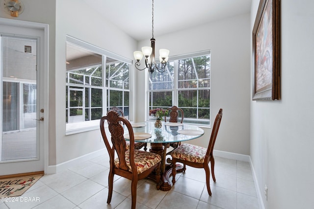 dining space with a notable chandelier, plenty of natural light, and light tile patterned flooring