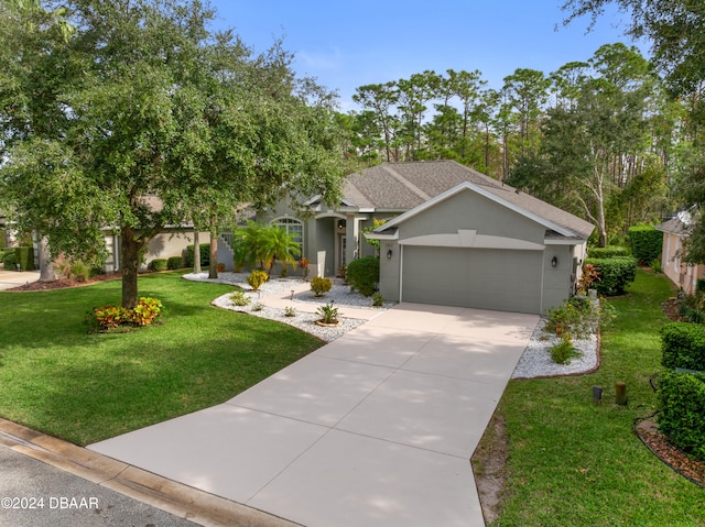 view of front of home with a garage and a front lawn