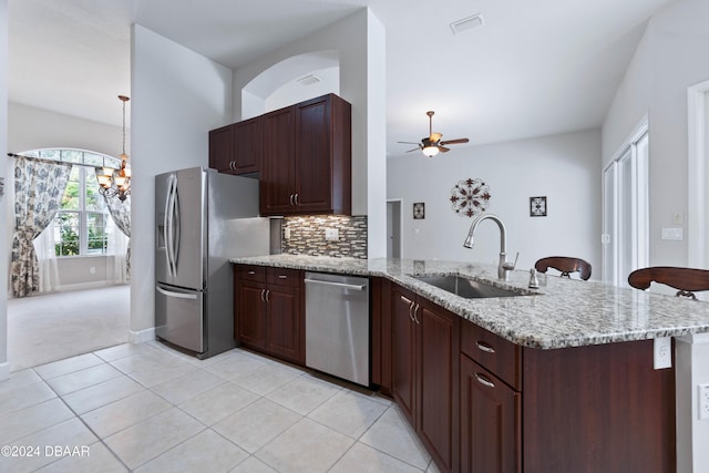 1317 Harwick Ln, Ormond Beach, FL 32174 - kitchen featuring a sink, appliances with stainless steel finishes, a peninsula, a ceiling fan, and light tile patterned floors