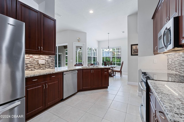 1317 Harwick Ln, Ormond Beach, FL 32174 - kitchen featuring appliances with stainless steel finishes, tasteful backsplash, baseboards, recessed lighting, and a chandelier