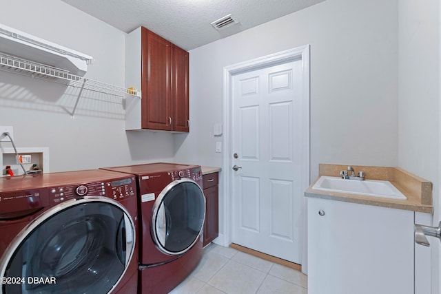 1317 Harwick Ln, Ormond Beach, FL 32174 - washroom featuring independent washer and dryer, cabinet space, light tile patterned floors, and a textured ceiling