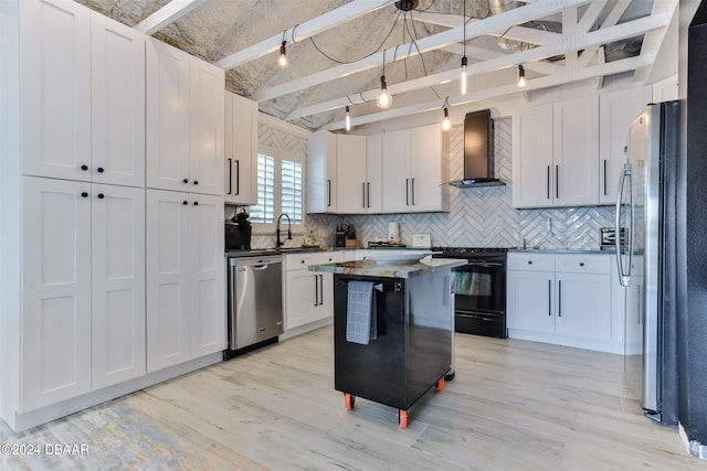 kitchen with white cabinetry, appliances with stainless steel finishes, and wall chimney exhaust hood