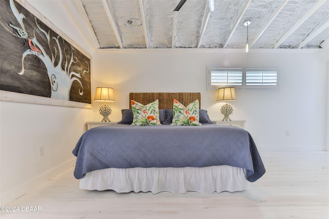 bedroom with ceiling fan, wood-type flooring, and lofted ceiling