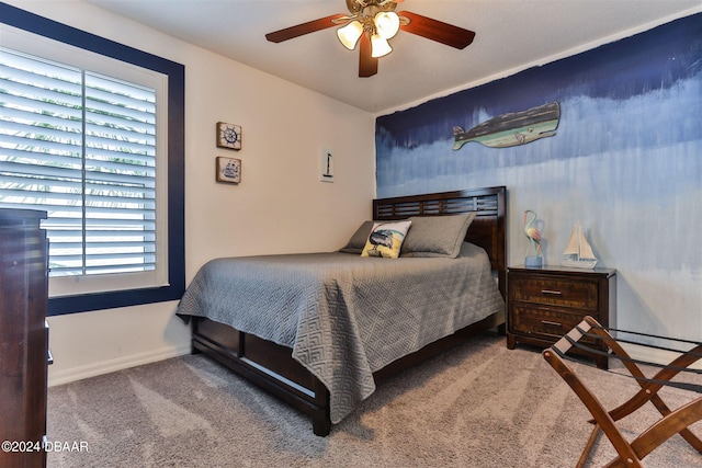 bedroom with ceiling fan, multiple windows, and carpet flooring