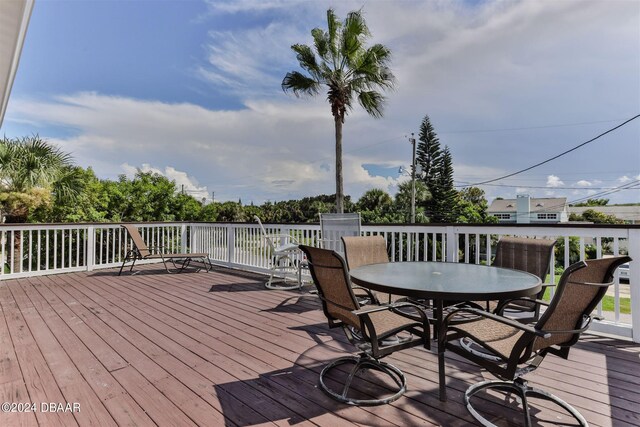 830 Maralyn Ave, New Smyrna Beach, FL 32169 - wooden terrace with outdoor dining area