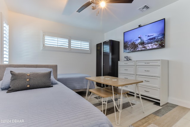 bedroom with light hardwood / wood-style floors and ceiling fan