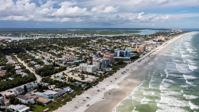 drone / aerial view with a water view and a beach view