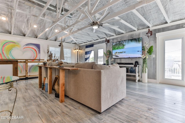 living room with hardwood / wood-style flooring, french doors, lofted ceiling, and ceiling fan