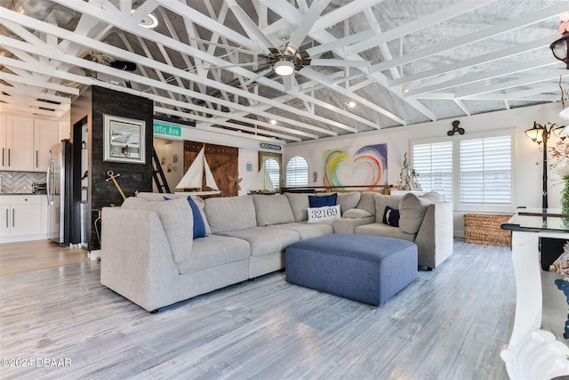 830 Maralyn Ave, New Smyrna Beach, FL 32169 - living area with light wood finished floors, lofted ceiling, and ceiling fan