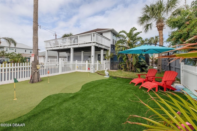 830 Maralyn Ave, New Smyrna Beach, FL 32169 - back of property featuring a putting area and a fenced backyard