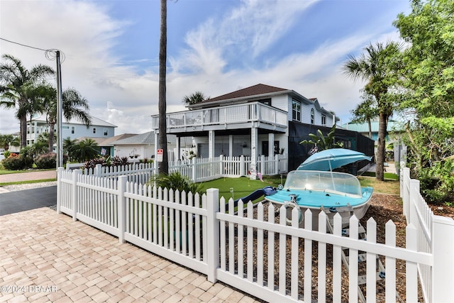 830 Maralyn Ave, New Smyrna Beach, FL 32169 - raised beach house featuring a fenced front yard