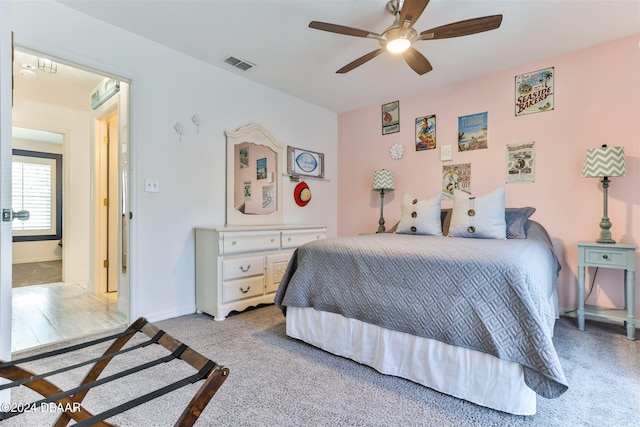 bedroom with ceiling fan and light colored carpet