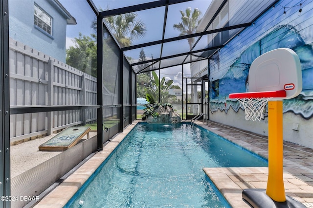 view of swimming pool featuring a patio, a lanai, and pool water feature