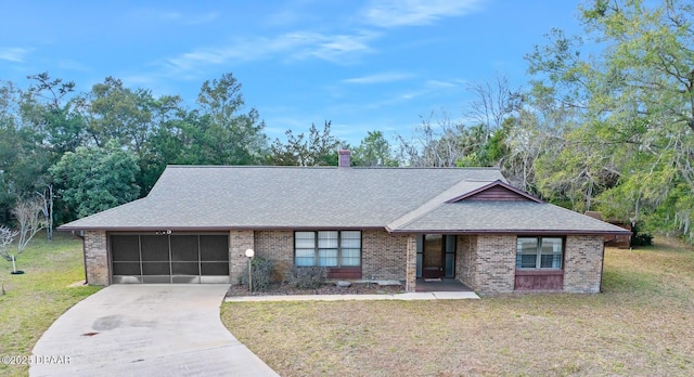 single story home featuring a garage and a front lawn