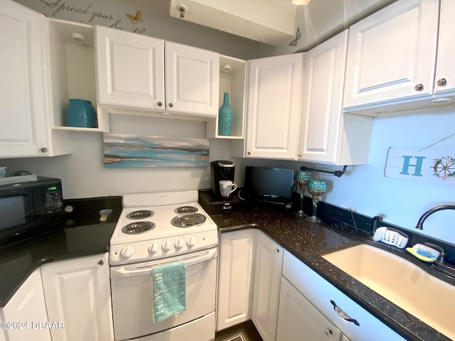 800 N Atlantic Ave Unit 516, Daytona Beach, FL 32118 - kitchen featuring electric range, a sink, black microwave, white cabinetry, and open shelves