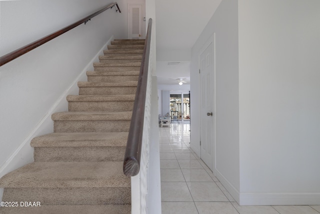 stairway with tile patterned flooring and baseboards