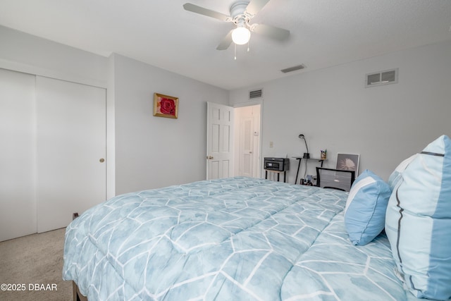 bedroom with visible vents, a closet, and carpet