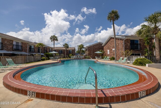 pool featuring a patio area and fence