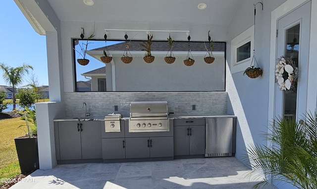 view of patio / terrace featuring area for grilling and sink