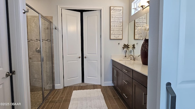 bathroom with vanity and a shower with door