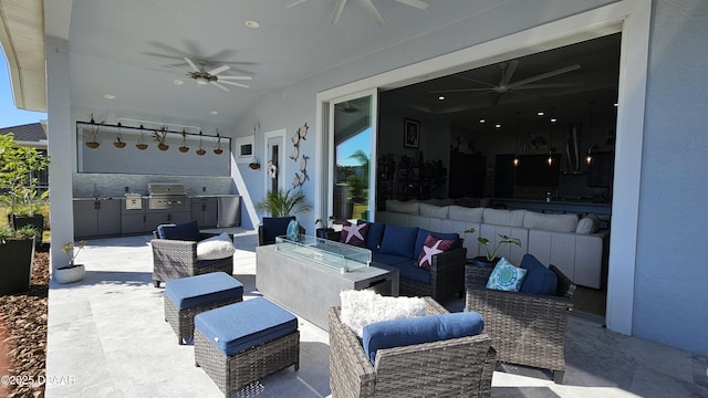 view of patio with ceiling fan, an outdoor kitchen, an outdoor living space, and area for grilling