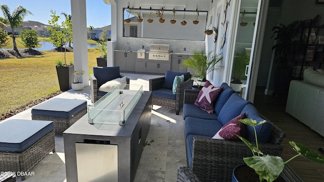 view of patio / terrace with outdoor lounge area, an outdoor kitchen, and grilling area