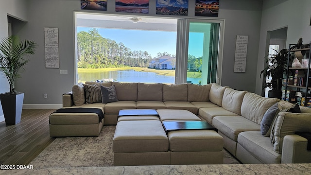 living room with a water view and hardwood / wood-style floors