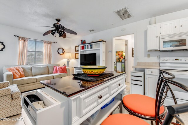 interior space featuring ceiling fan